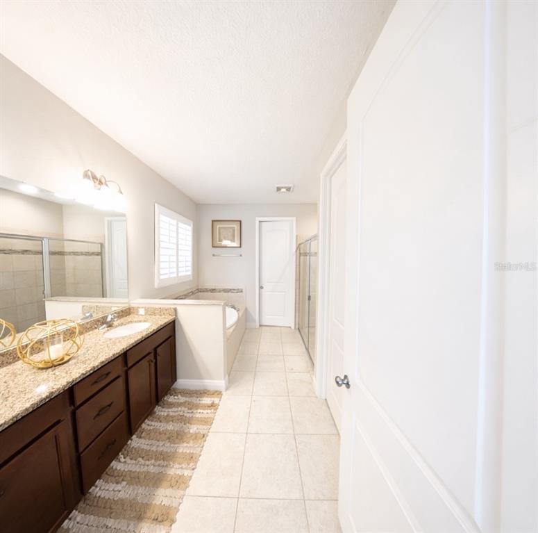 1216 Old Windsor Way Spring Hill, FL 34609 - Photo 12 of 31 a bathroom with a granite countertop sink and a bathtub