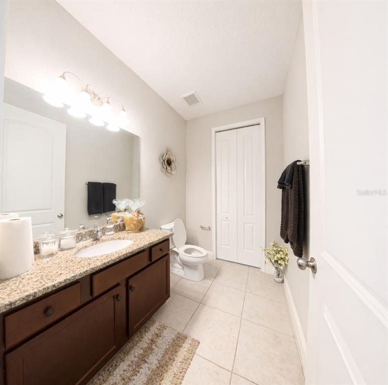 1216 Old Windsor Way Spring Hill, FL 34609 - Photo 16 of 31 a bathroom with a double vanity sink and mirror