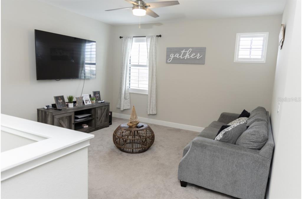 1216 Old Windsor Way Spring Hill, FL 34609 - Photo 17 of 31 a living room with furniture and a flat screen tv