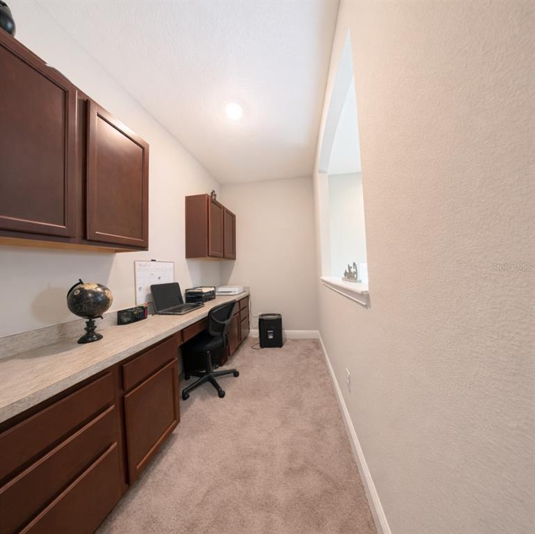 1216 Old Windsor Way Spring Hill, FL 34609 - Photo 20 of 31 a kitchen with a sink and cabinets