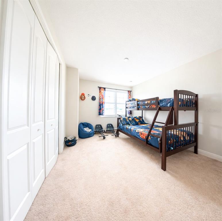 1216 Old Windsor Way Spring Hill, FL 34609 - Photo 22 of 31 a bedroom with furniture and white walls