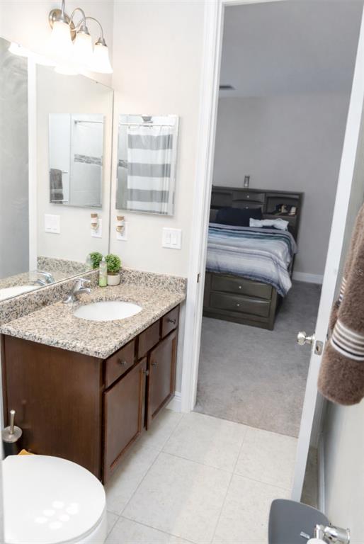 1216 Old Windsor Way Spring Hill, FL 34609 - Photo 26 of 31 a bathroom with a granite countertop sink and a mirror
