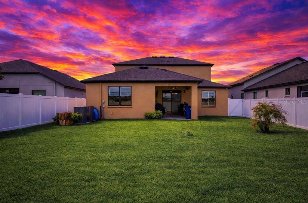 1216 Old Windsor Way Spring Hill, FL 34609 - Photo 29 of 31 a view of a backyard with potted plants and a large tree