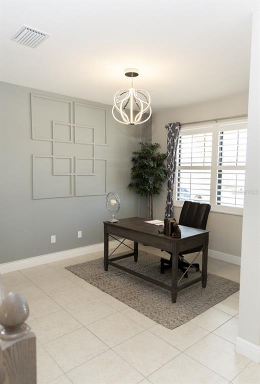 1216 Old Windsor Way Spring Hill, FL 34609 - Photo 4 of 31 a living room with furniture a window and a table