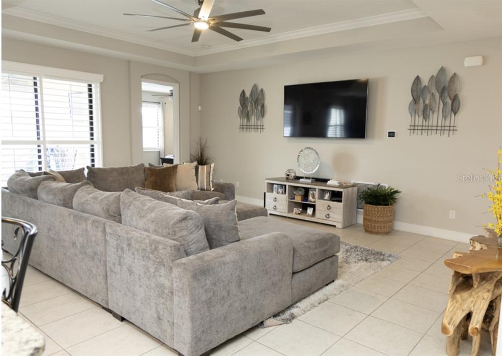 1216 Old Windsor Way Spring Hill, FL 34609 - Photo 5 of 31 a living room with furniture and a flat screen tv