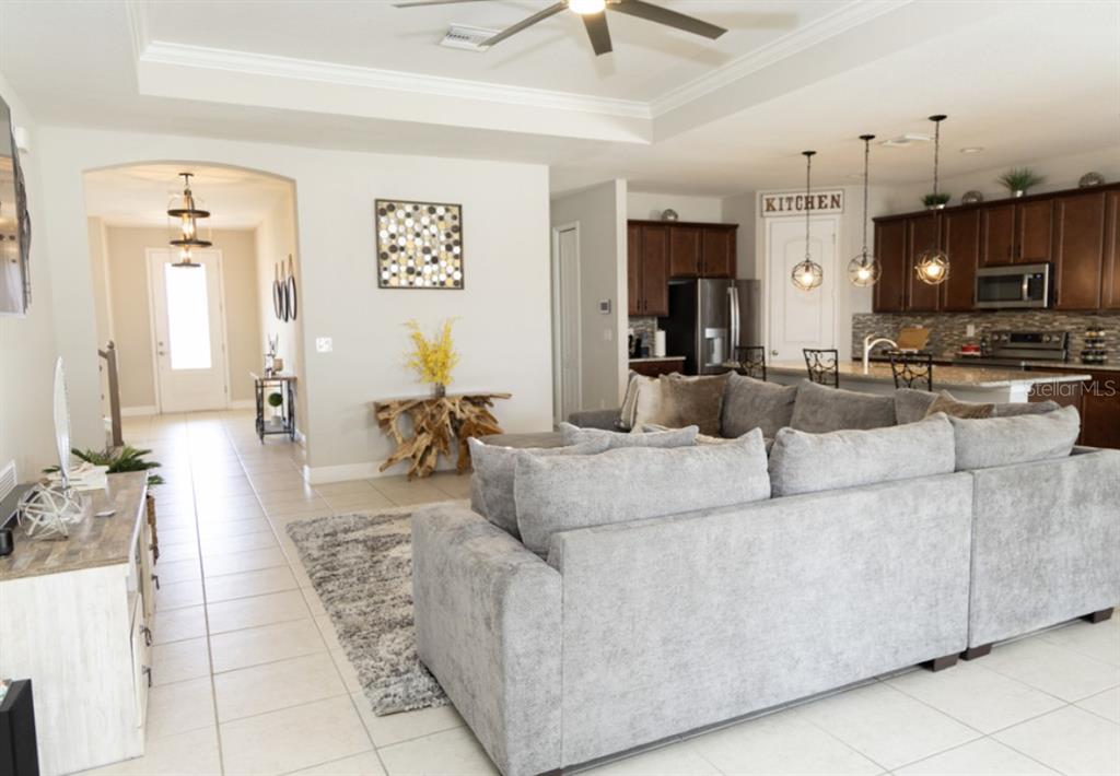 1216 Old Windsor Way Spring Hill, FL 34609 - Photo 7 of 31 a living room with furniture and a flat screen tv