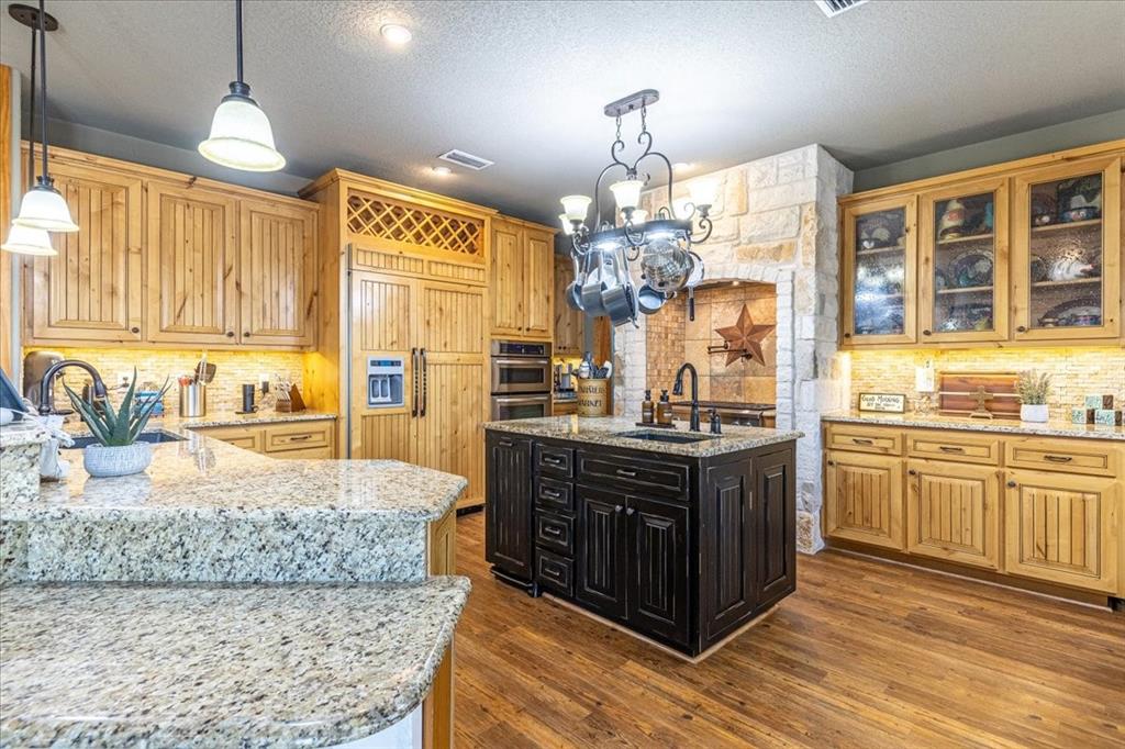 a large kitchen with kitchen island granite countertop a large island in the center and stainless steel appliances