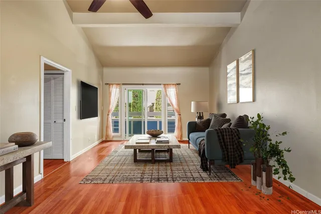 a living room with furniture and wooden floor