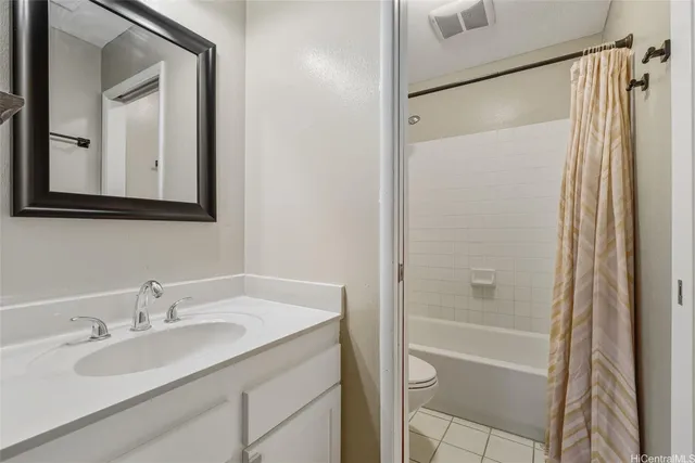 a bathroom with a granite countertop sink mirror vanity and shower
