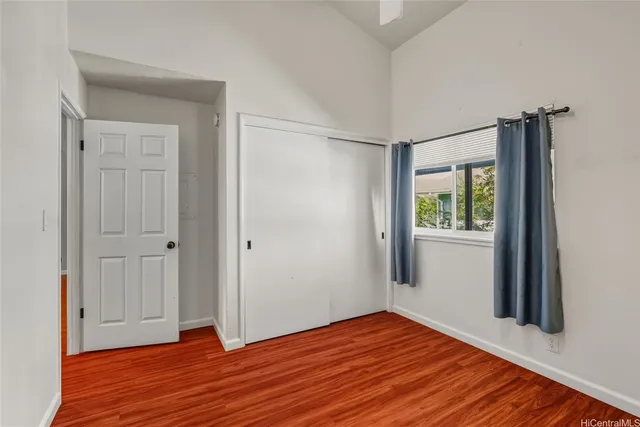 a view of a room with wooden floor and window