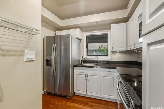 a kitchen with stainless steel appliances granite countertop a refrigerator and a sink
