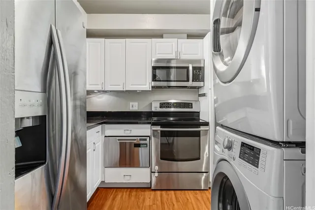 a kitchen with stainless steel appliances granite countertop a stove a microwave and a refrigerator