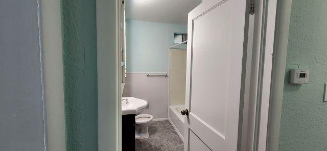 108 East Maple Street Keene, TX 76059 - Photo 13 of 14 a bathroom with a toilet