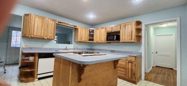 108 East Maple Street Keene, TX 76059 - Photo 5 of 14 a kitchen that has a sink a stove and cabinets