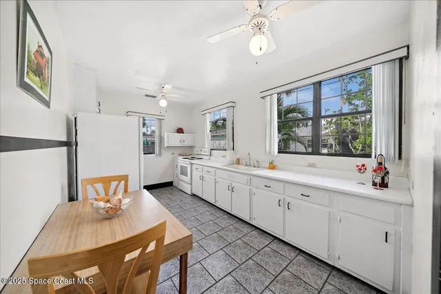 a large white kitchen with a large window