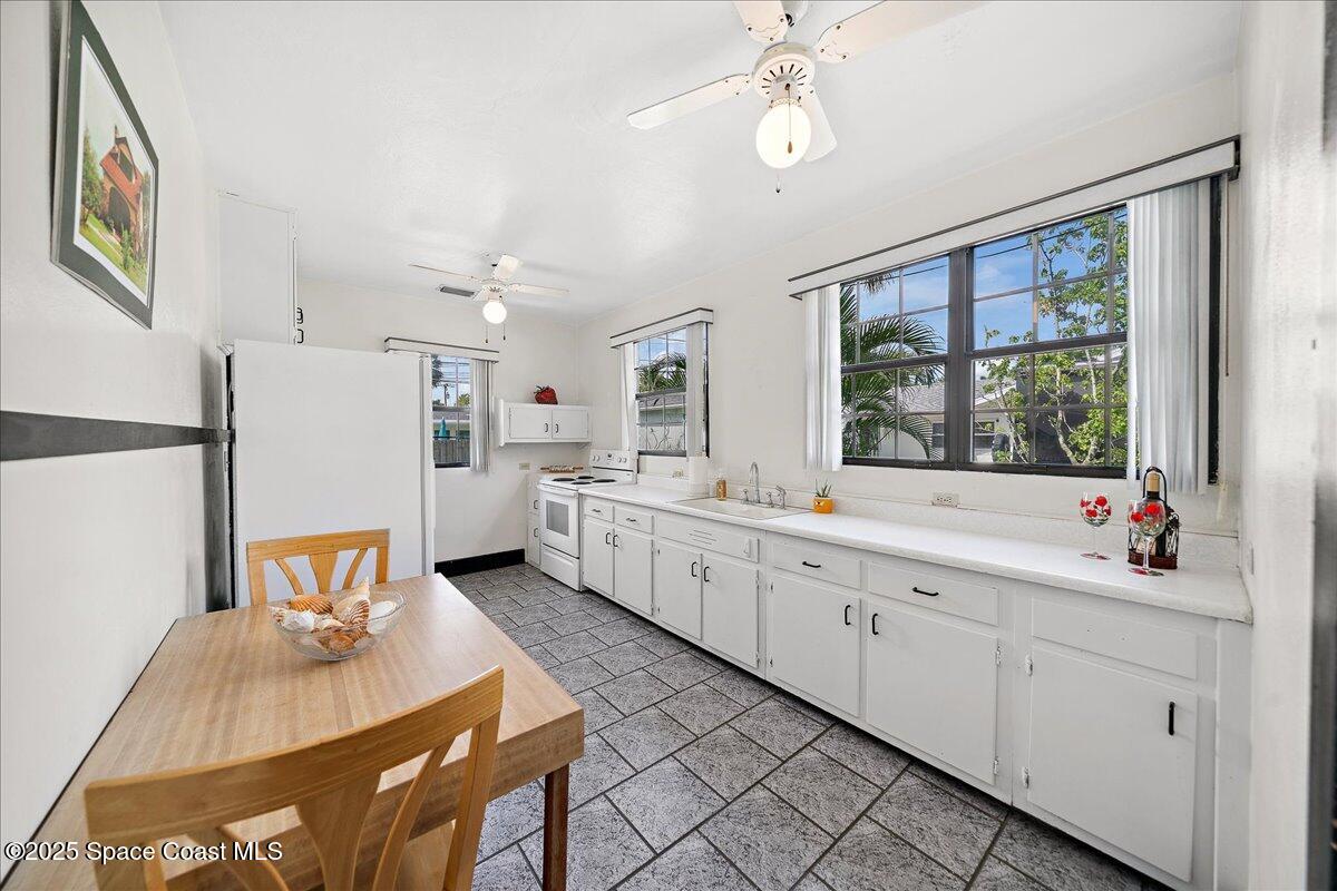 415 2nd Avenue Indialantic, FL 32903 - Photo 17 of 51 a large white kitchen with a large window