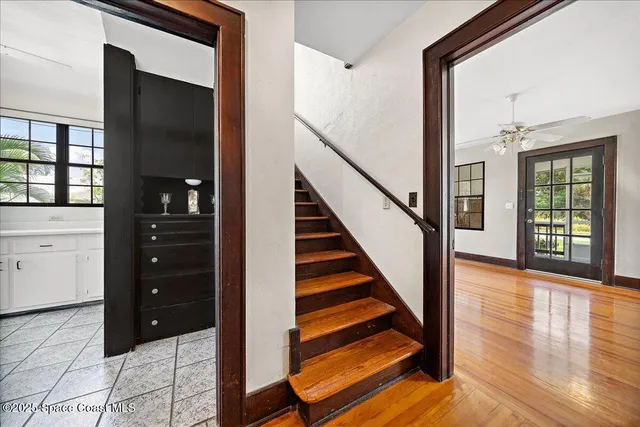 a view of an entryway with wooden floor and staircase