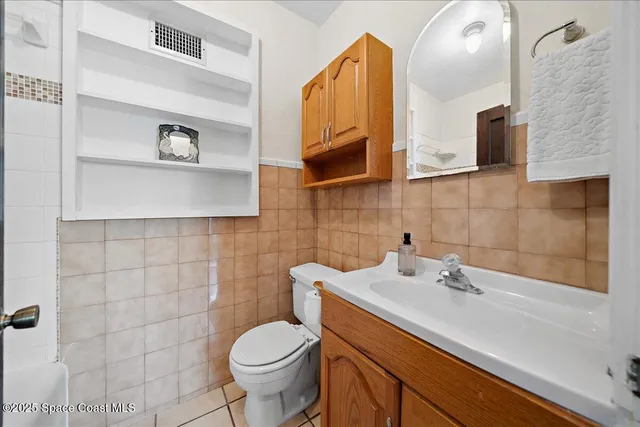 a bathroom with a sink a toilet and mirror