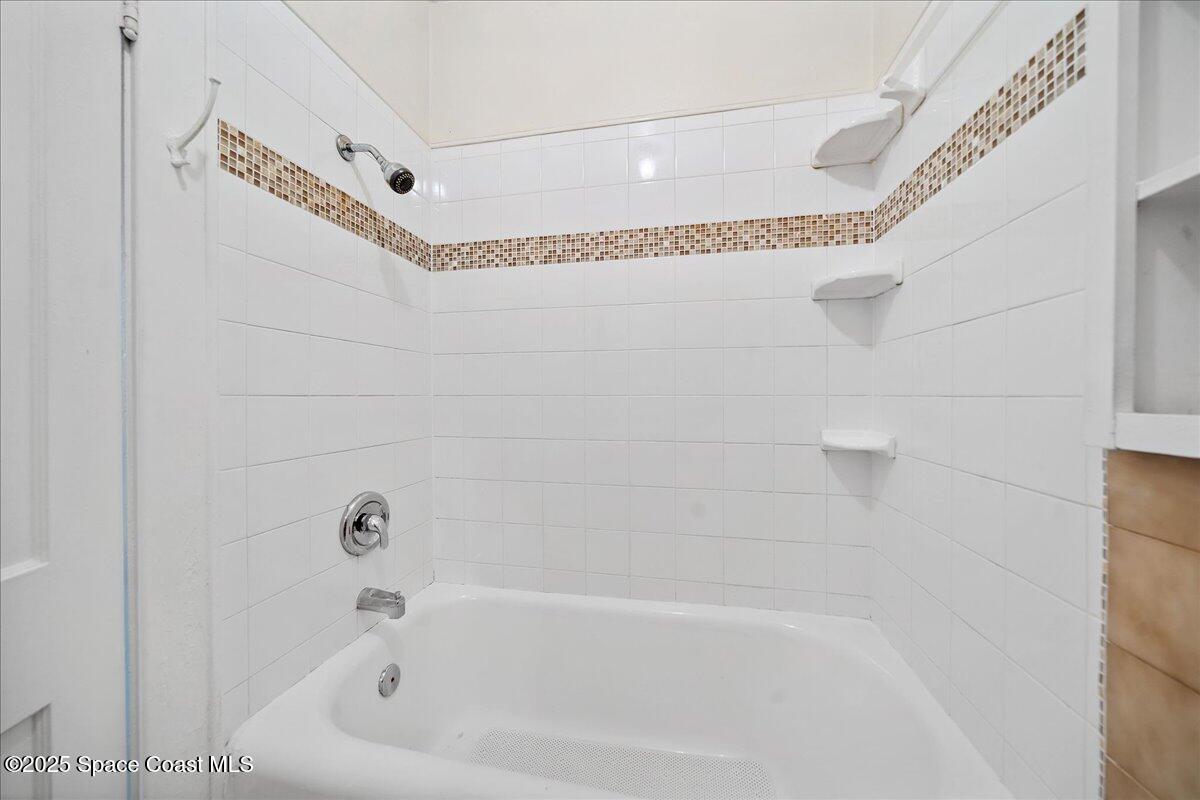 415 2nd Avenue Indialantic, FL 32903 - Photo 23 of 51 a bathroom with a bathtub and a shower