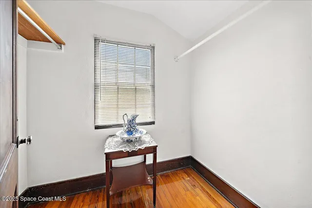 a workspace room with furniture and wooden floor