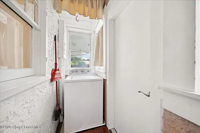 a view of a hallway with wooden floor and a dining room
