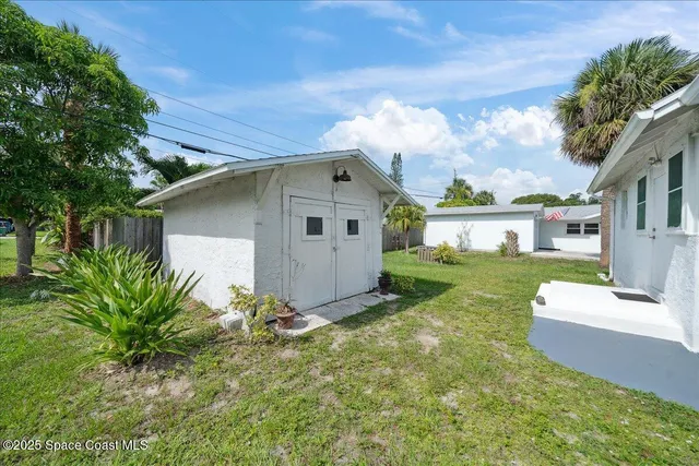 an aerial view of a house with a yard basket ball court and outdoor seating