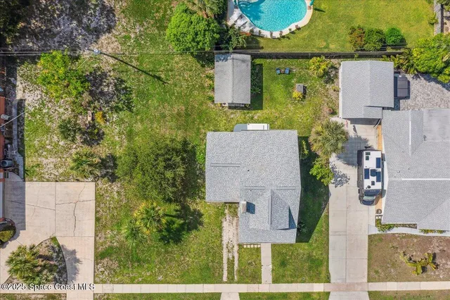 an aerial view of residential houses with outdoor space