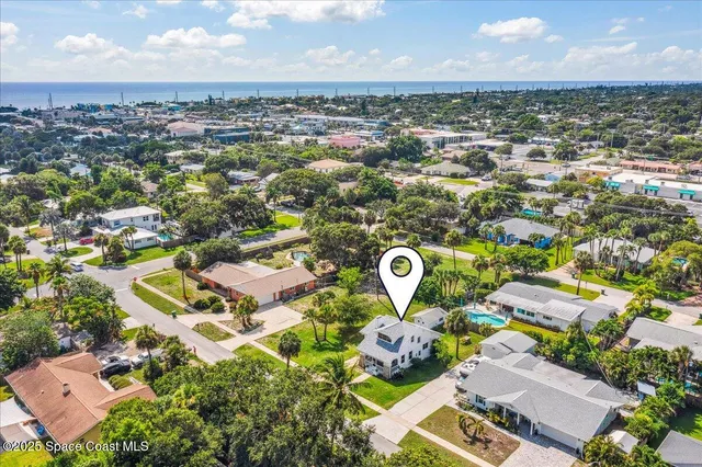 an aerial view of residential houses with outdoor space