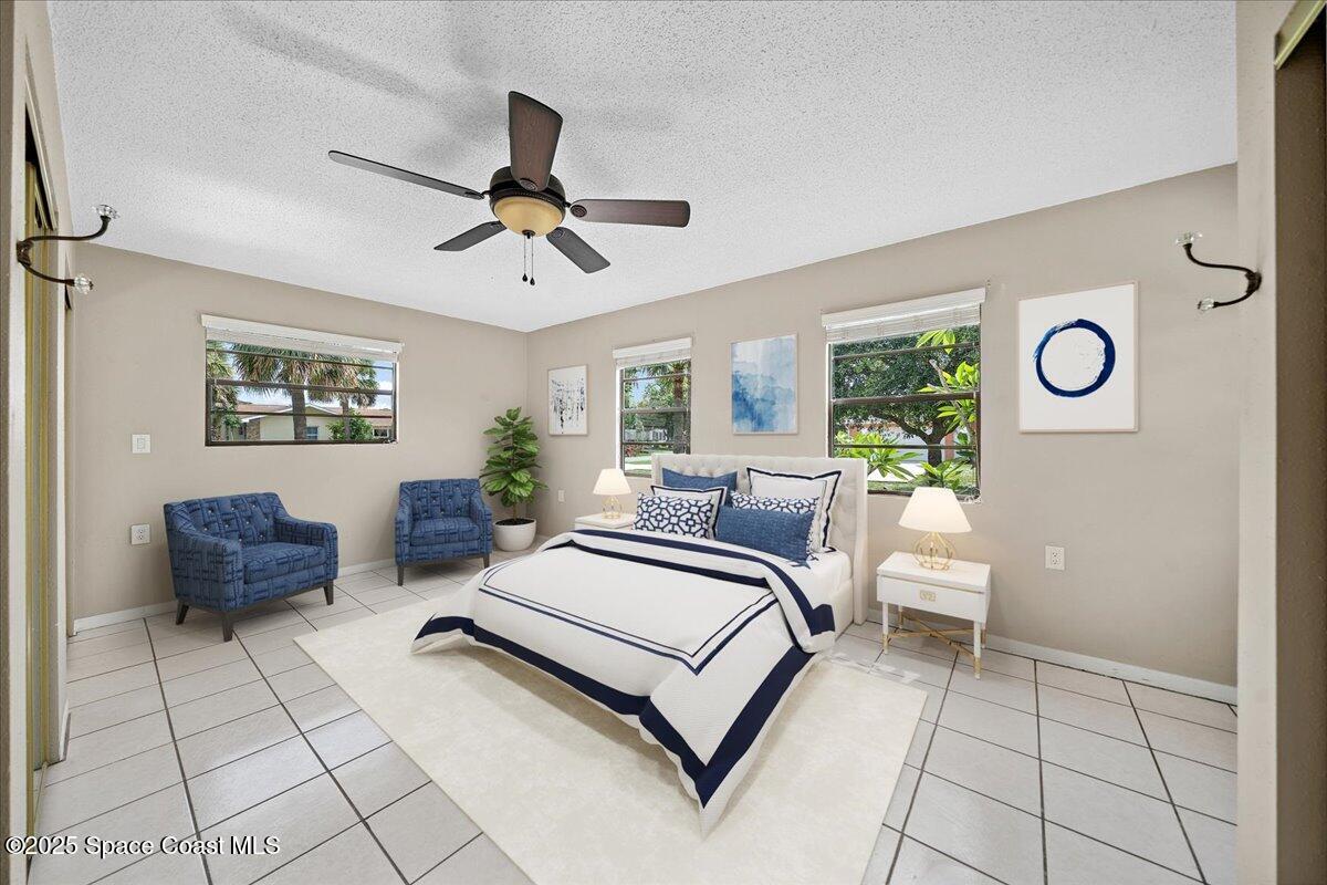 415 2nd Avenue Indialantic, FL 32903 - Photo 7 of 51 a bedroom with a bed and a chandelier