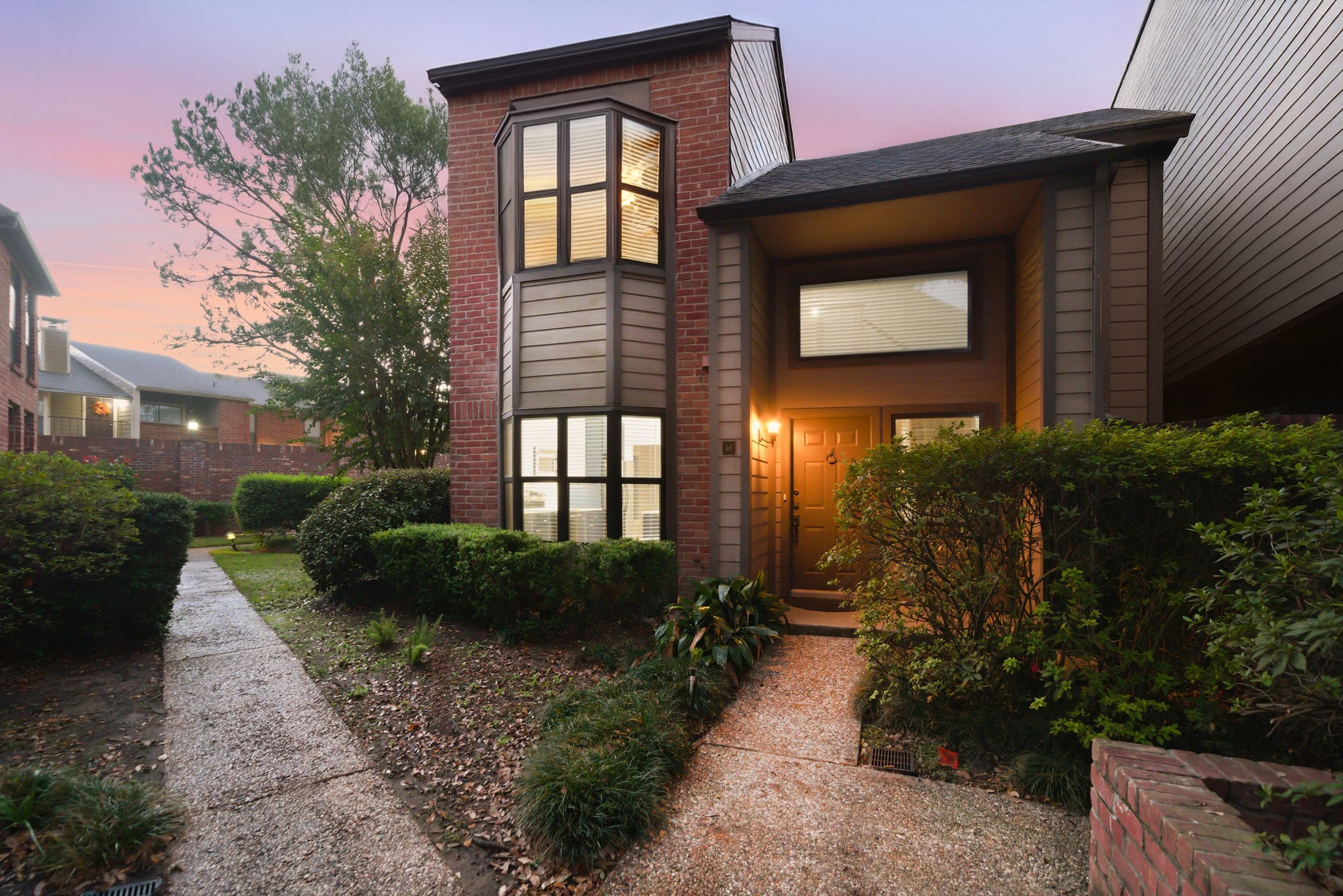 7447 Cambridge Street, Unit 65 Houston, TX 77054 - Photo 11 of 42 a front view of a house with garden
