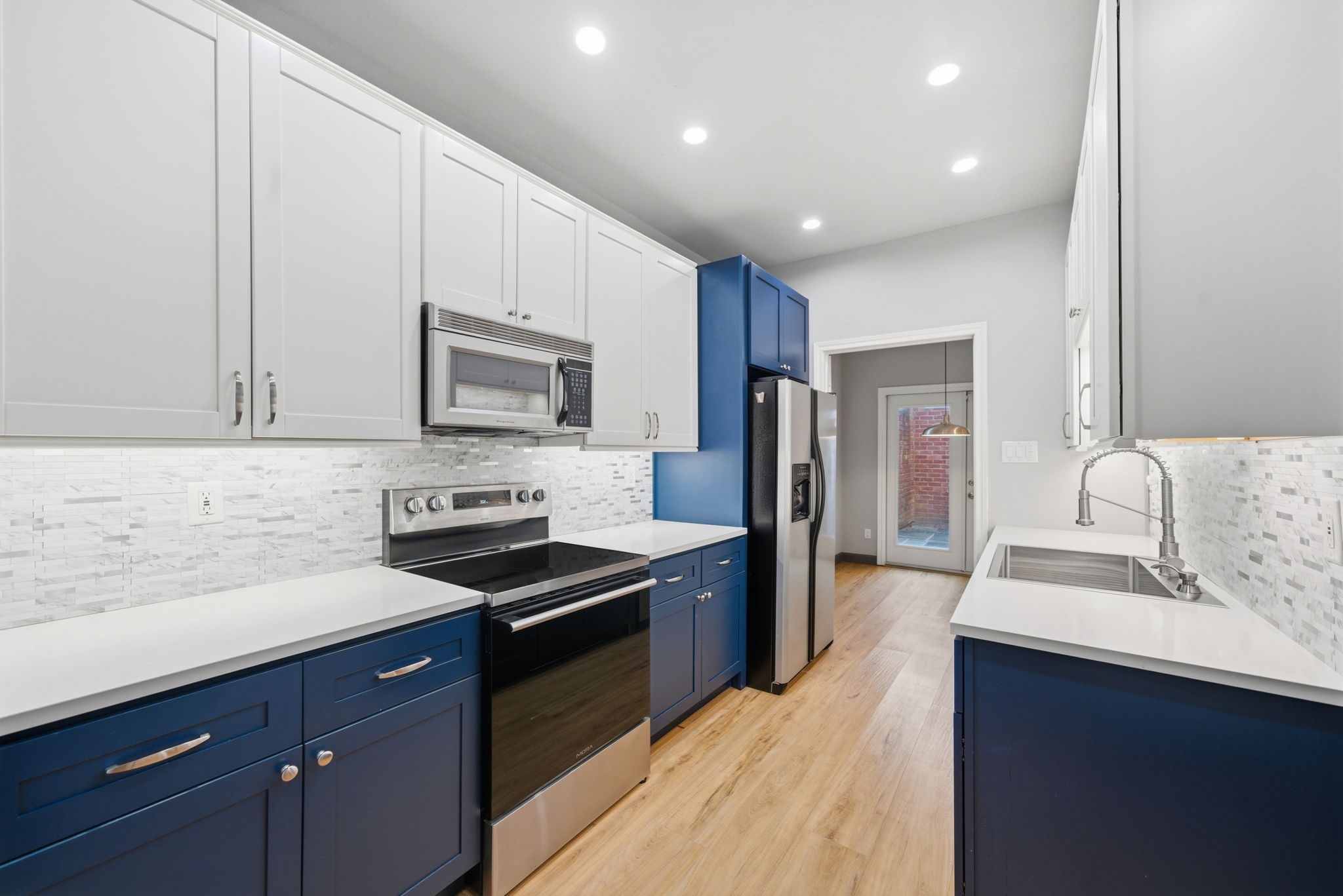 7447 Cambridge Street, Unit 65 Houston, TX 77054 - Photo 17 of 42 a kitchen with granite countertop a sink stove and refrigerator