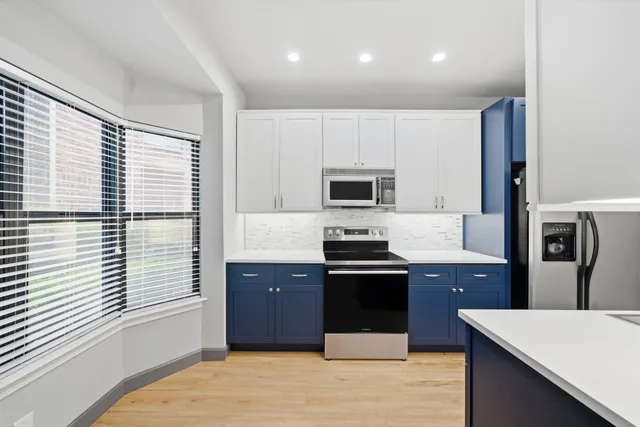 a bathroom with a granite countertop toilet a sink and mirror