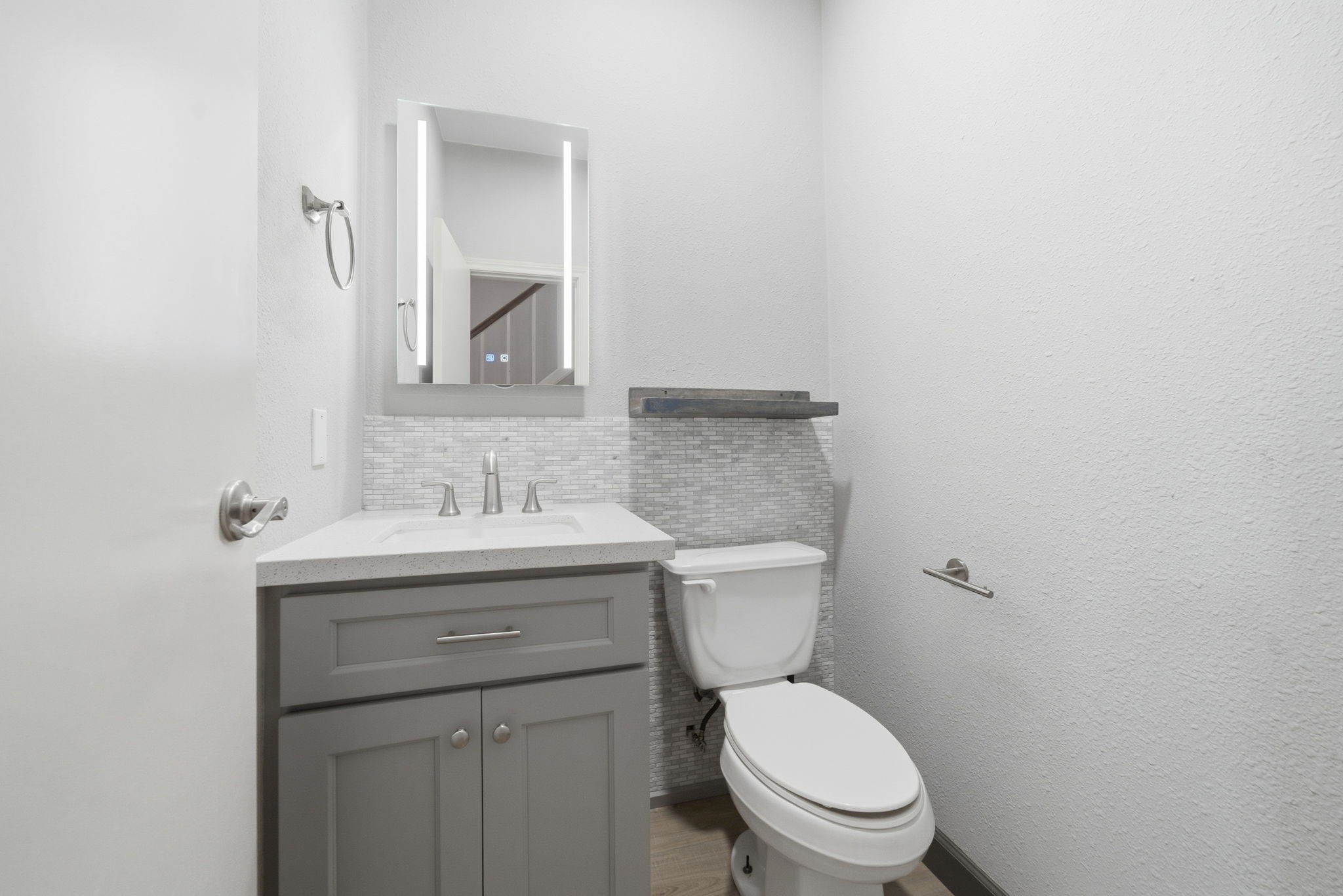 7447 Cambridge Street, Unit 65 Houston, TX 77054 - Photo 19 of 42 a bathroom with a granite countertop toilet a sink and mirror