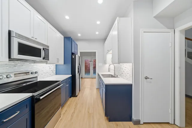 a kitchen with granite countertop stainless steel appliances and wooden cabinets