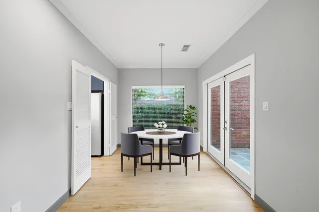 a view of a balcony with chairs and a potted plant