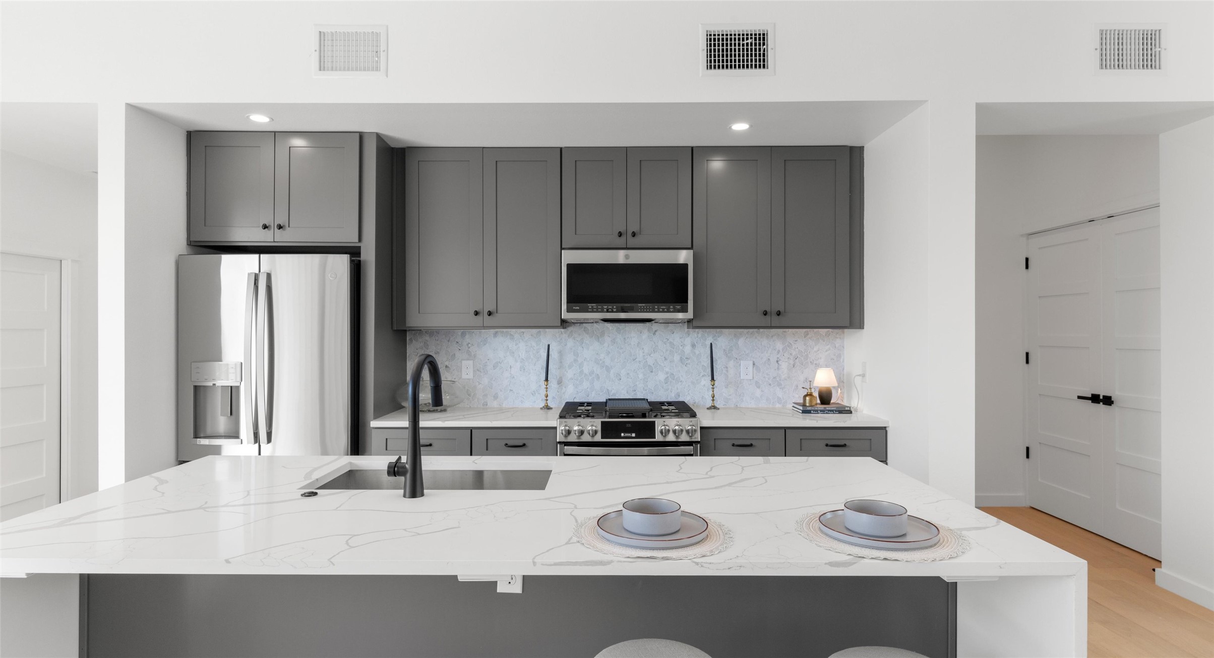 5912 Harold Court, Unit 107 Austin, TX 78721 - Photo 11 of 35 The island kitchen pairs stainless appliances with room to gather — ideal for cooking together or hosting friends. Model No. 105 Shown.