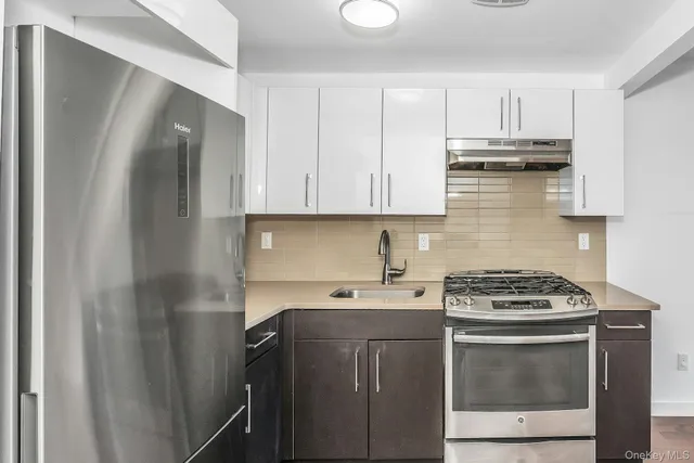 a kitchen with a sink stove and cabinets