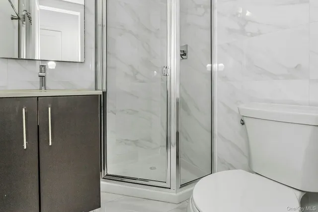 a bathroom with a toilet and a shower