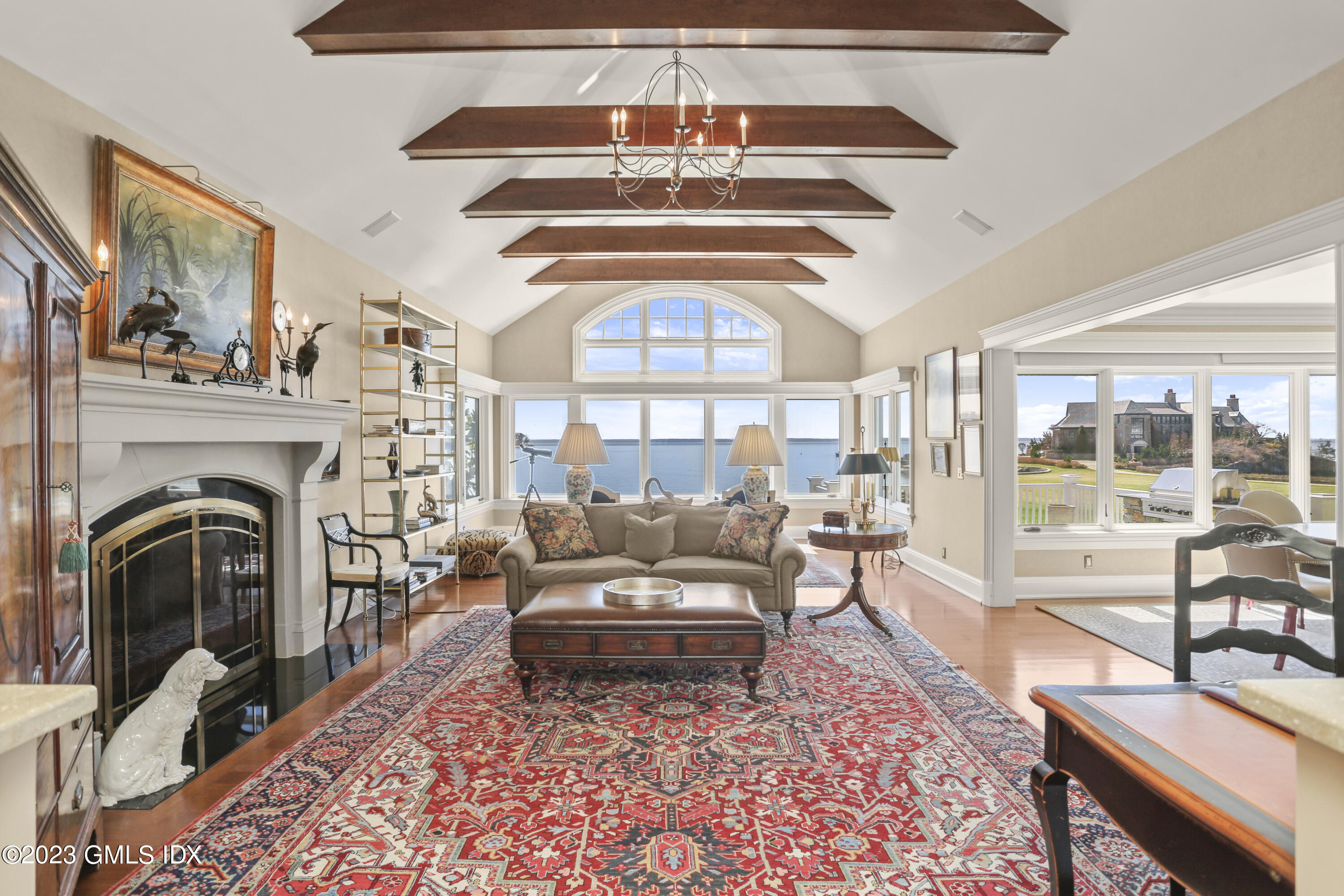 18 Pilot Rock Lane Riverside, CT 06878 - Photo 16 of 50 a living room with furniture a fireplace and a floor to ceiling window