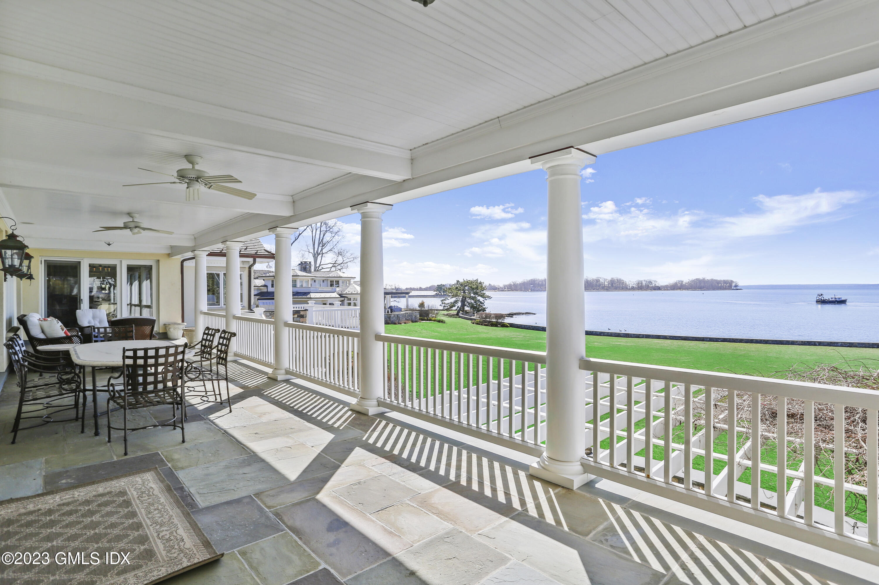 18 Pilot Rock Lane Riverside, CT 06878 - Photo 22 of 50 a view of a chairs and table in patio with wooden floor