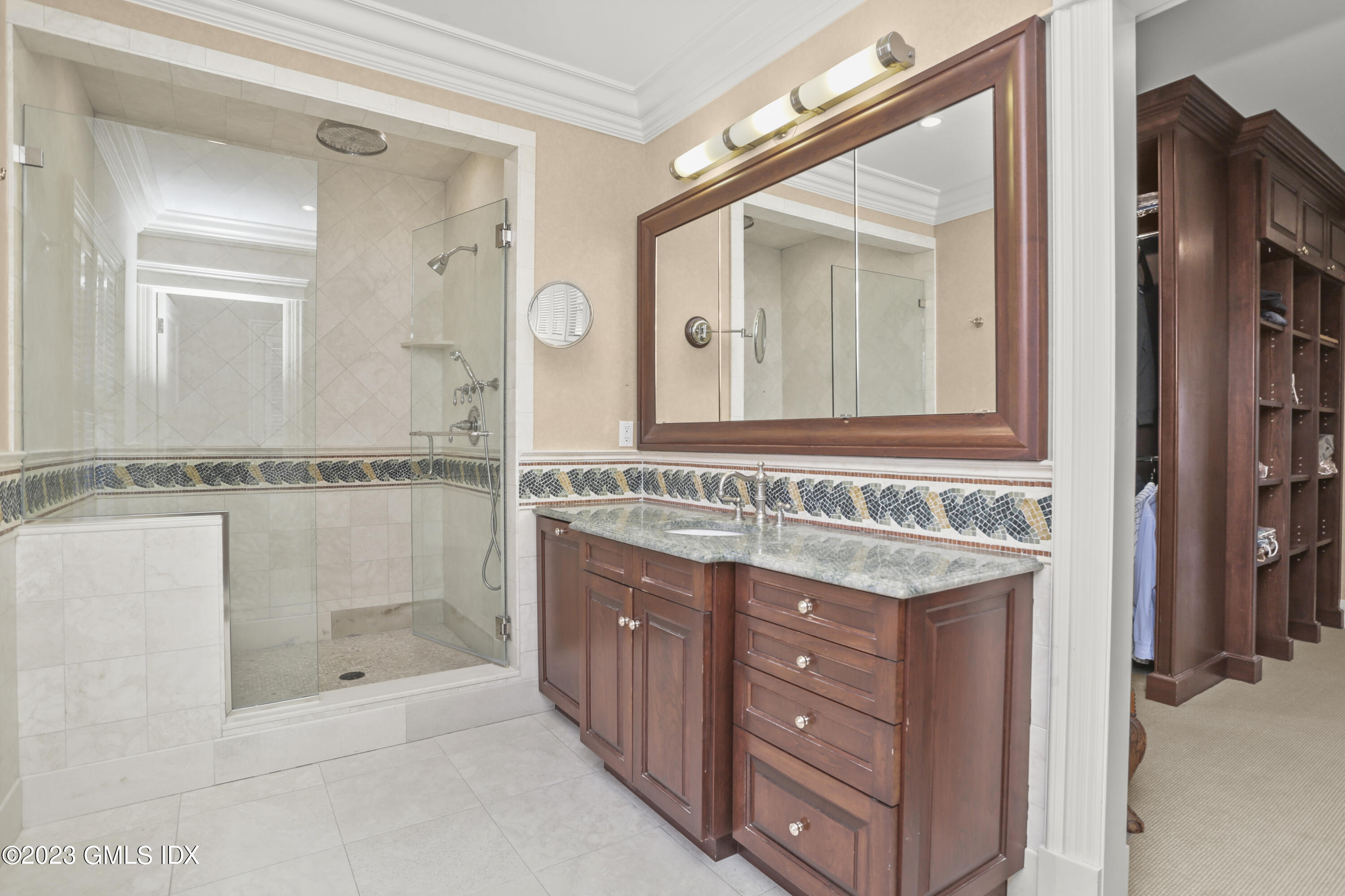 18 Pilot Rock Lane Riverside, CT 06878 - Photo 28 of 50 a bathroom with a granite countertop sink a mirror and a shower