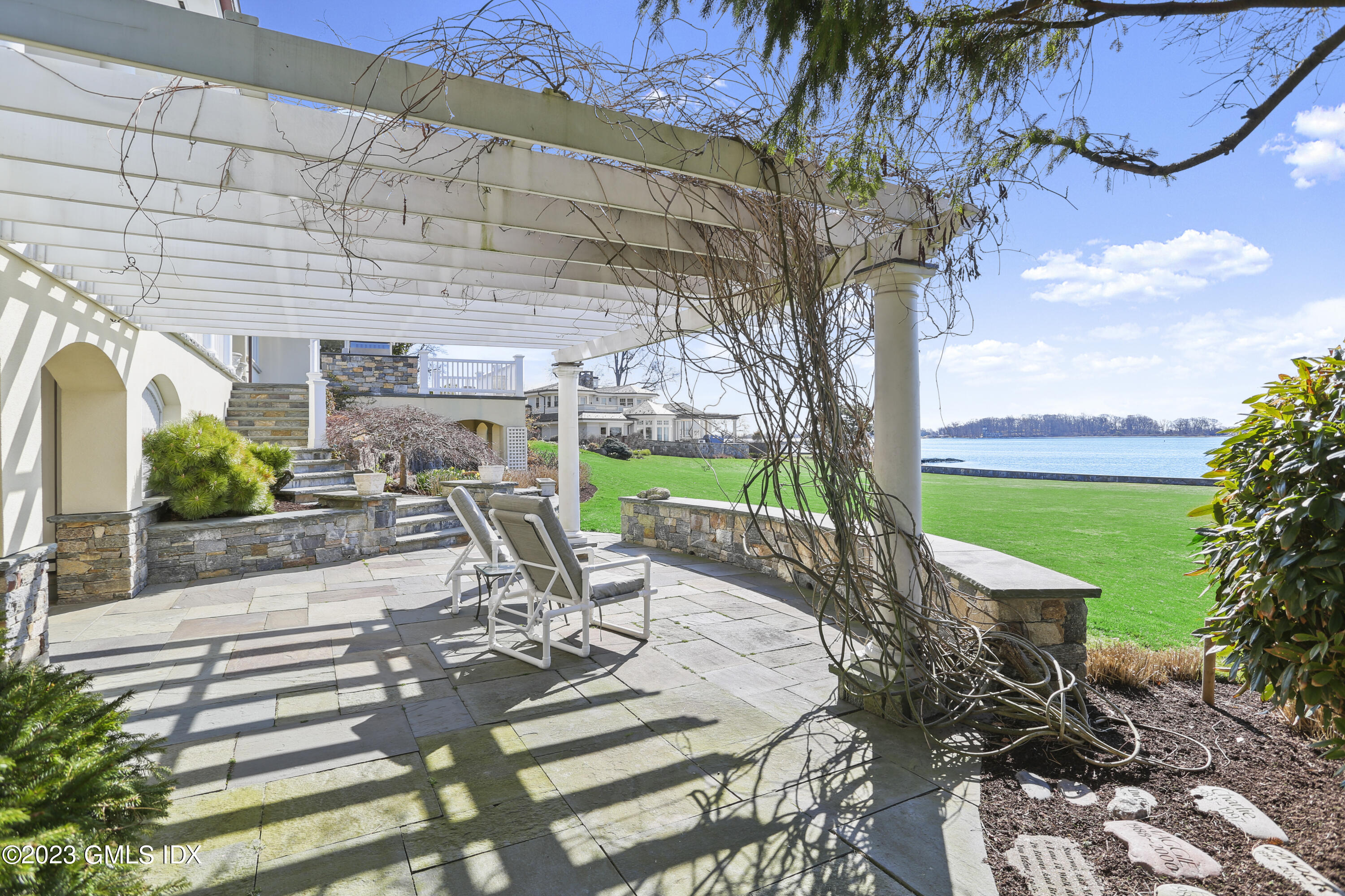 18 Pilot Rock Lane Riverside, CT 06878 - Photo 42 of 50 a view of a patio with table and chairs potted plants and large tree