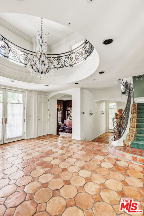 527 North Maple Drive Beverly Hills, CA 90210 - Photo 12 of 54 a view of a hallway with a chandelier and living room view