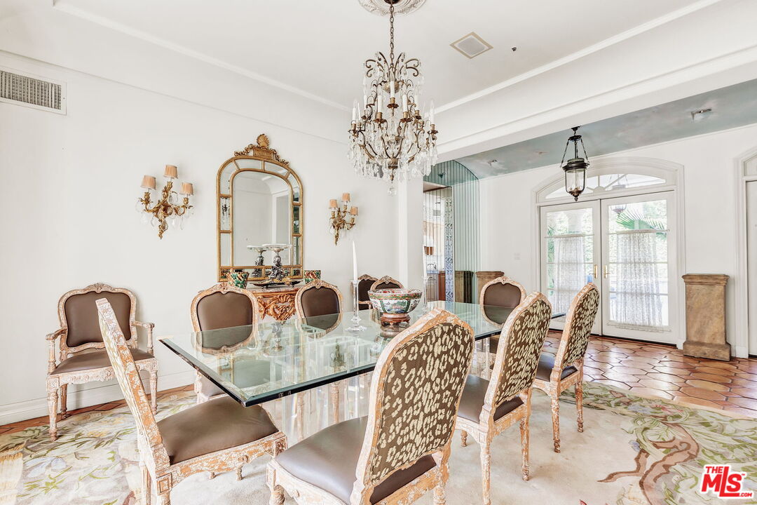 527 North Maple Drive Beverly Hills, CA 90210 - Photo 18 of 54 a view of a dining room with furniture and wooden floor