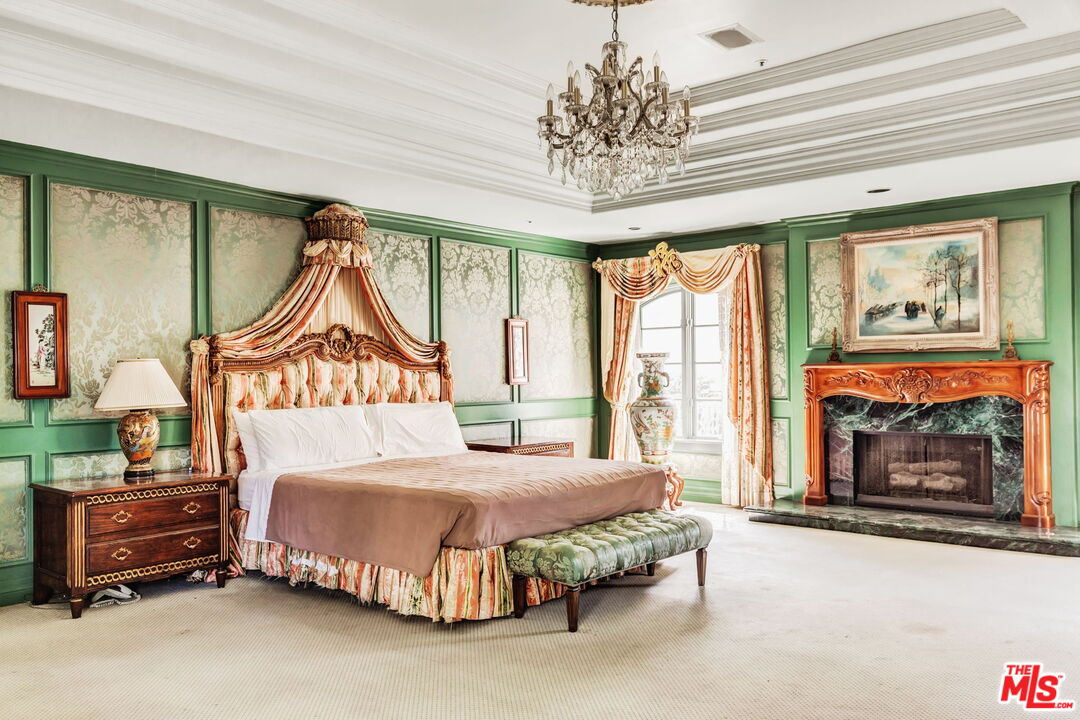 527 North Maple Drive Beverly Hills, CA 90210 - Photo 27 of 54 a bedroom with a bed and a fireplace