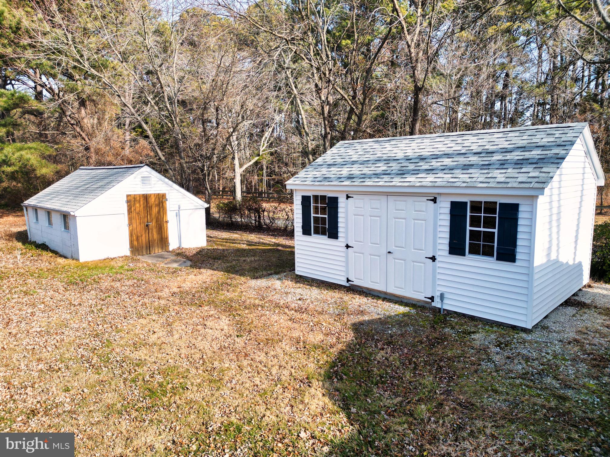 22769 Almost Neavitt Road Bozman, MD 21612 - Photo 13 of 44 a backyard of a house with large trees and wooden fence