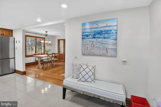 a dining room with wooden floor and a chandelier