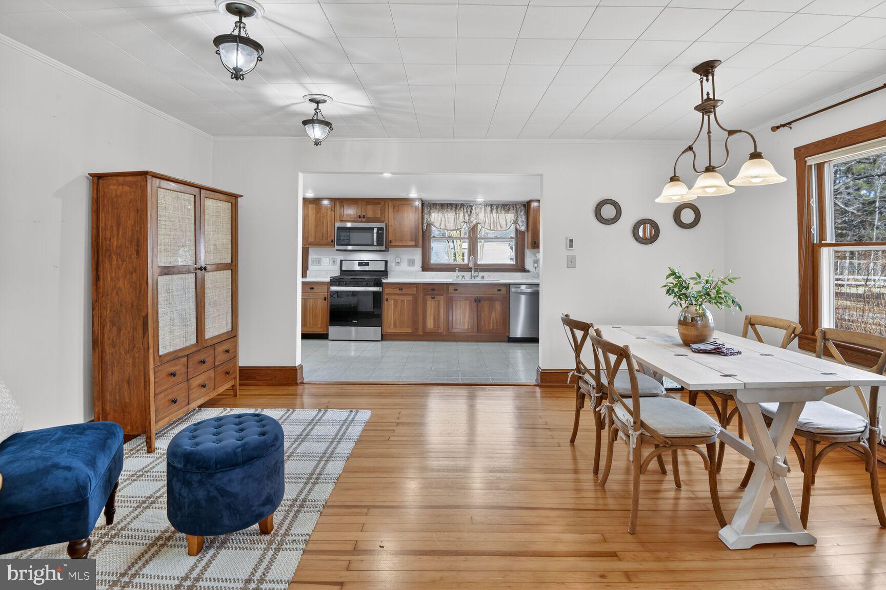 22769 Almost Neavitt Road Bozman, MD 21612 - Photo 19 of 44 a living room with furniture and a chandelier