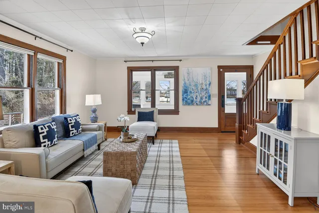a view of staircase with wooden floor and a large window