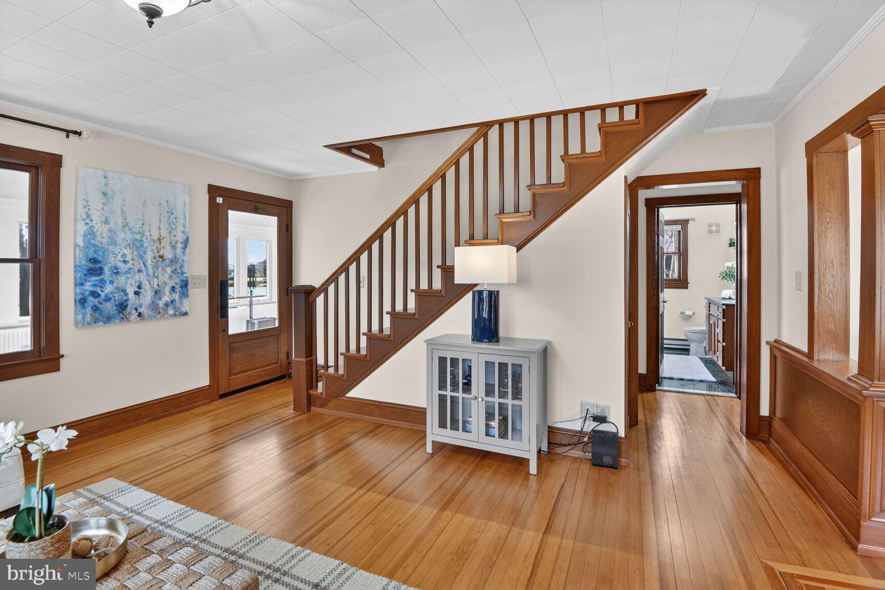 22769 Almost Neavitt Road Bozman, MD 21612 - Photo 22 of 44 a view of staircase with wooden floor and a large window